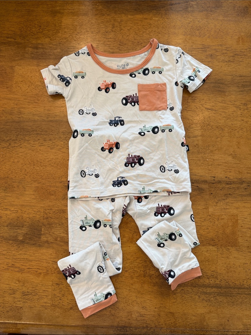 Kyte BABY Neutral White Tractor Pajama Set with Rust Pocket Trim
